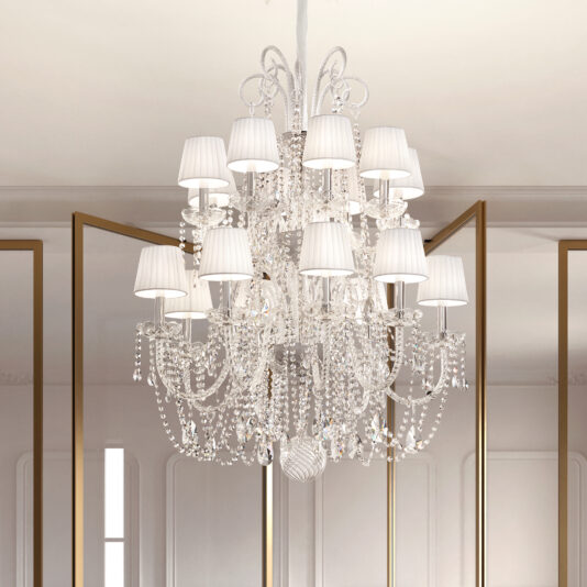 The Classic Style Clear Crystal Chandelier (Copy) features white lampshades and ornate crystals, hanging from the ceiling in a bright room with large mirrors and minimalist decor.