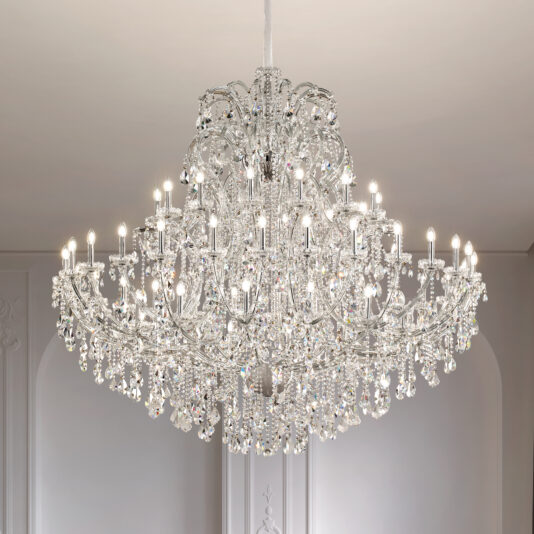 A Classic Style Empire Crystal Chandelier with multiple tiers and candle-shaped bulbs hangs from a white ceiling in an elegant, well-lit room.