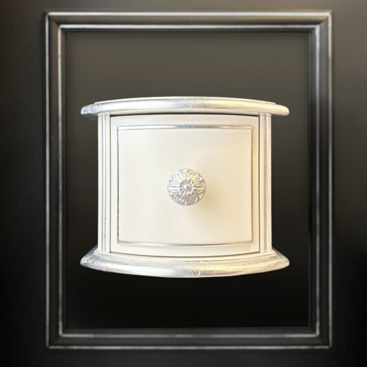 The Small Classic Style Floating Bedside features a cream-colored drawer with silver trim and a round silver knob, all set in a black shadow box frame—ideal as a floating bedside accent.