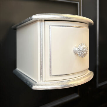 Small Classic Style Floating Bedside The Small Classic Style Floating Bedside in cream and silver features a single ornate knob and decorative trim, beautifully set against a dark background.