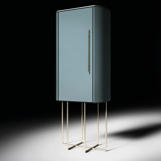 A modern blue cabinet with vertical ridges, tall gold handle, and slim gold legs stands on a white-black gradient surface, paired elegantly with the Classic Baroque Style Mirror (Copy) against a dark backdrop.