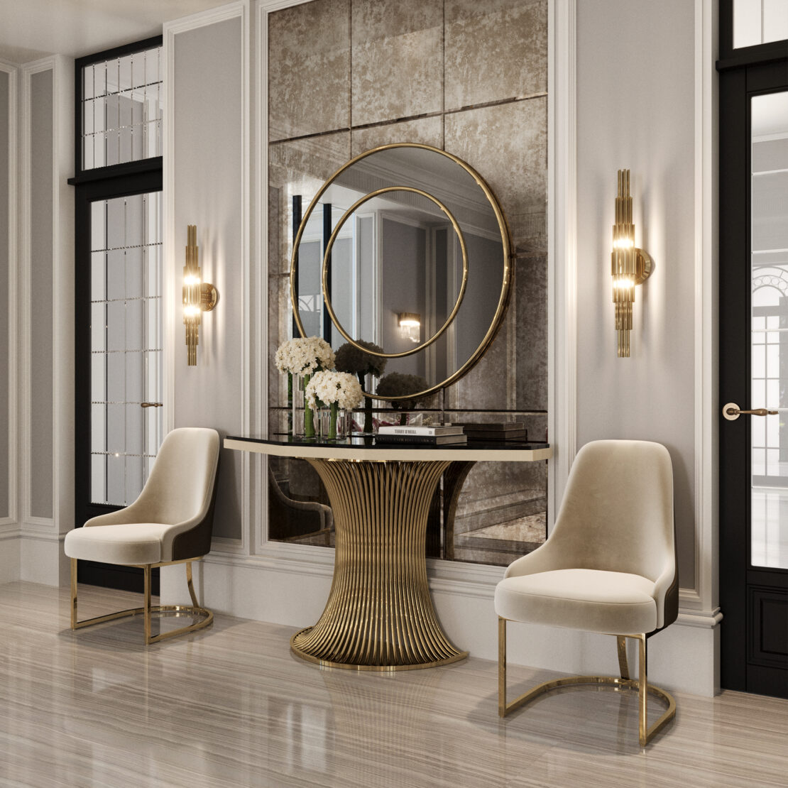 Elegant foyer with two cream chairs flanking a Marble Demi Console (Copy), topped with white flowers and books. A large, round gold-framed mirror hangs above, accented by wall sconces and paneled walls for a sophisticated touch.