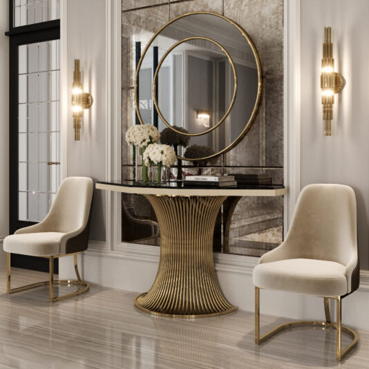 Elegant entryway with two beige velvet chairs, a Marble Demi Console (Copy), white flowers in vases, circular mirrors, and gold wall sconces on either side, creating a modern, luxurious interior design.