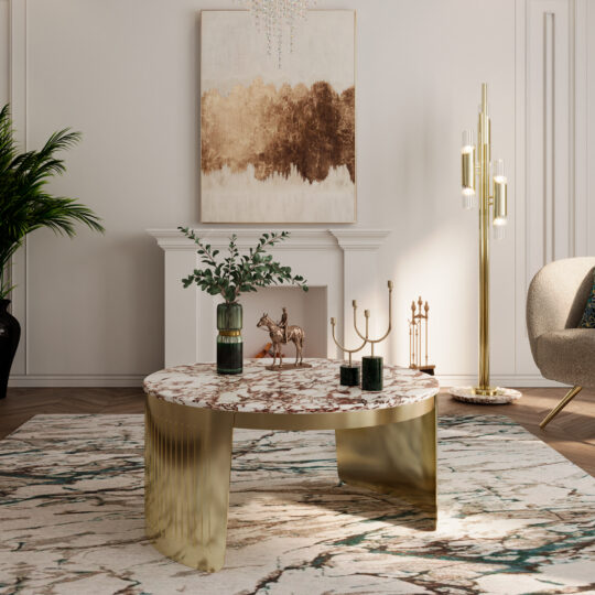 A modern living room with a Modern Marble Coffee Table, gold accents, a green vase with foliage, decorative gold pieces, a white fireplace, abstract wall art, a gold floor lamp, and a patterned rug.