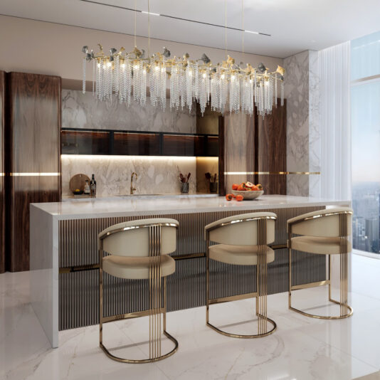 Contemporary Leaf Chandelier With Crystal Drops A modern kitchen features a marble island, three gold and beige barstools, wooden accents, a bowl of fruit, and a Contemporary Wavy Tiered Chandelier (Copy) above. Floor-to-ceiling windows fill the space with natural light.
