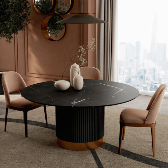 A modern dining room showcases a Round Contemporary Lacquered Dining Table, three beige velvet chairs, decorative white vases, wall mirrors, and a large window with a city skyline view in the background.