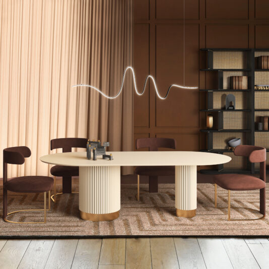 A modern dining room with a cream oval table, four Modern Dining Chairs (Copy) in burgundy, a beige patterned rug, brown paneled walls, a black decor shelf, and an overhead wave-shaped pendant light.