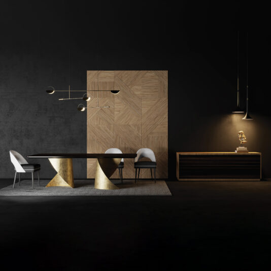 A modern dining room features the Contemporary Ebony Veneered Dining Table with gold geometric bases, three white chairs, a wooden accent wall, pendant lighting, and a sideboard with decor set against dark walls.