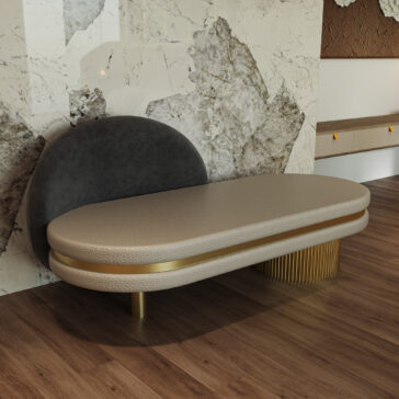 Contemporary Geometric Chaise Longue The Contemporary Geometric Chaise Longue features a curved gray backrest, beige cushioned seat, gold accents, and a ribbed gold support. It sits on a wooden floor with a marble-patterned wall as the backdrop.