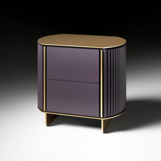The Contemporary Lacquered Curved Bedside Cabinet features an oval shape, gold top and legs, purple ribbed sides, and two smooth purple drawers, set against a gradient black and white background.