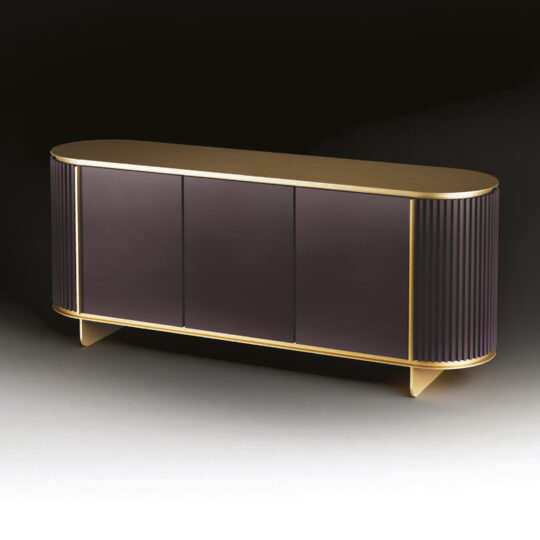 The Contemporary Lacquered Curved Sideboard features a smooth dark front, rounded edges, vertical side grooves, and gold trim on the top, bottom, and feet, creating a striking look against a dark background.