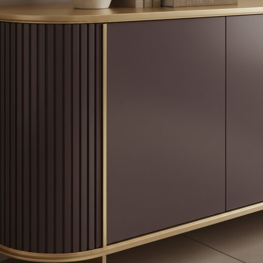 Contemporary Lacquered Curved Sideboard The Contemporary Lacquered Curved Sideboard features matt dark brown doors, vertical grooves on one side, and a light wood top and trim. A potted plant and books on its smooth surface enhance its minimalist design.