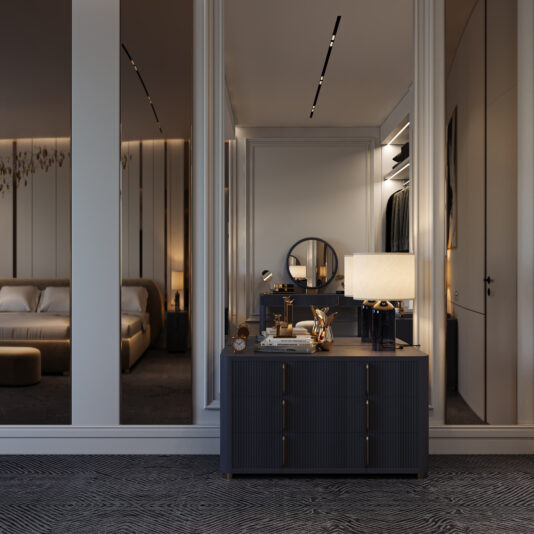 Contemporary Ribbed Lacquered Chest of Drawers A modern bedroom featuring a Contemporary Ribbed Lacquered Chest of Drawers, a table lamp, and vanity items before a large mirror reflecting a round mirror, closet, and part of the bed with soft lighting and elegant decor.