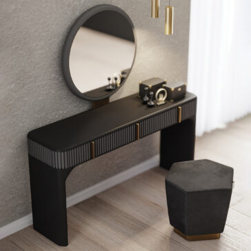 The Contemporary Veneered Dressing Table features a round mirror, black tabletop with gold accents, and a hexagonal black stool. Decorative boxes and items adorn the softly lit dressing table near sheer curtains.