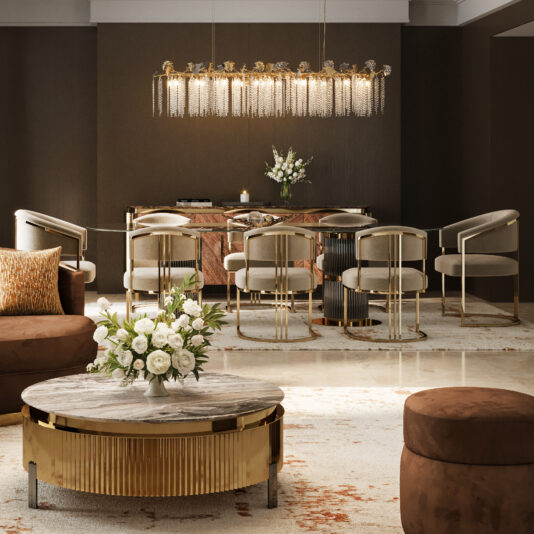 Elegant dining room with a gold and marble table, eight Modern Art Deco Style Dining Chairs, a round marble coffee table, brown ottomans, floral arrangements, and a modern chandelier featuring hanging chains.