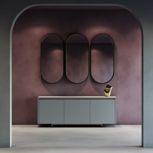 Modern Lacquered Sideboard A minimalist room featuring the Contemporary Lacquered Curved Sideboard (Copy), a gold abstract sculpture, and three tall oval mirrors on a mauve wall, framed by a large arched doorway.