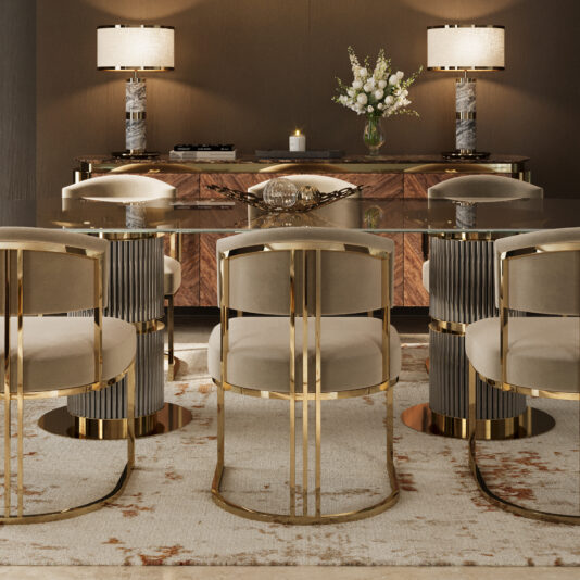 A modern dining room showcases a Contemporary Oval Glass Dining Table, gold and beige upholstered chairs, a patterned rug, and a wooden sideboard with two lamps, a vase of white flowers, and decor accents.