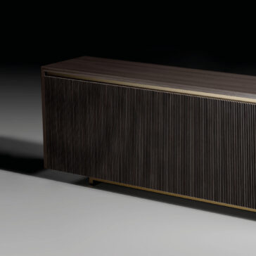 Modern Veneered Ribbed Sideboard The Modern Lacquered Sideboard (Copy) features dark wood with vertical grooves on the front panel, shown partially against a black and gray gradient background.