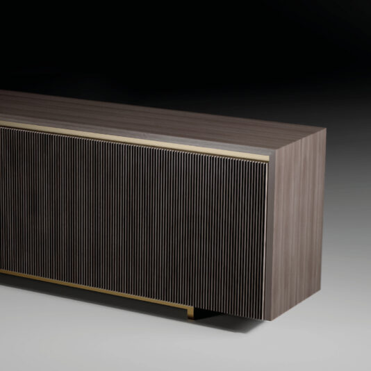 Modern Veneered Ribbed Sideboard The Modern Lacquered Sideboard (Copy) features a smooth top, vertically grooved front panels, and a subtle metallic-accented base. Displayed against a dark gradient background, this sideboard adds sophistication to any contemporary space.