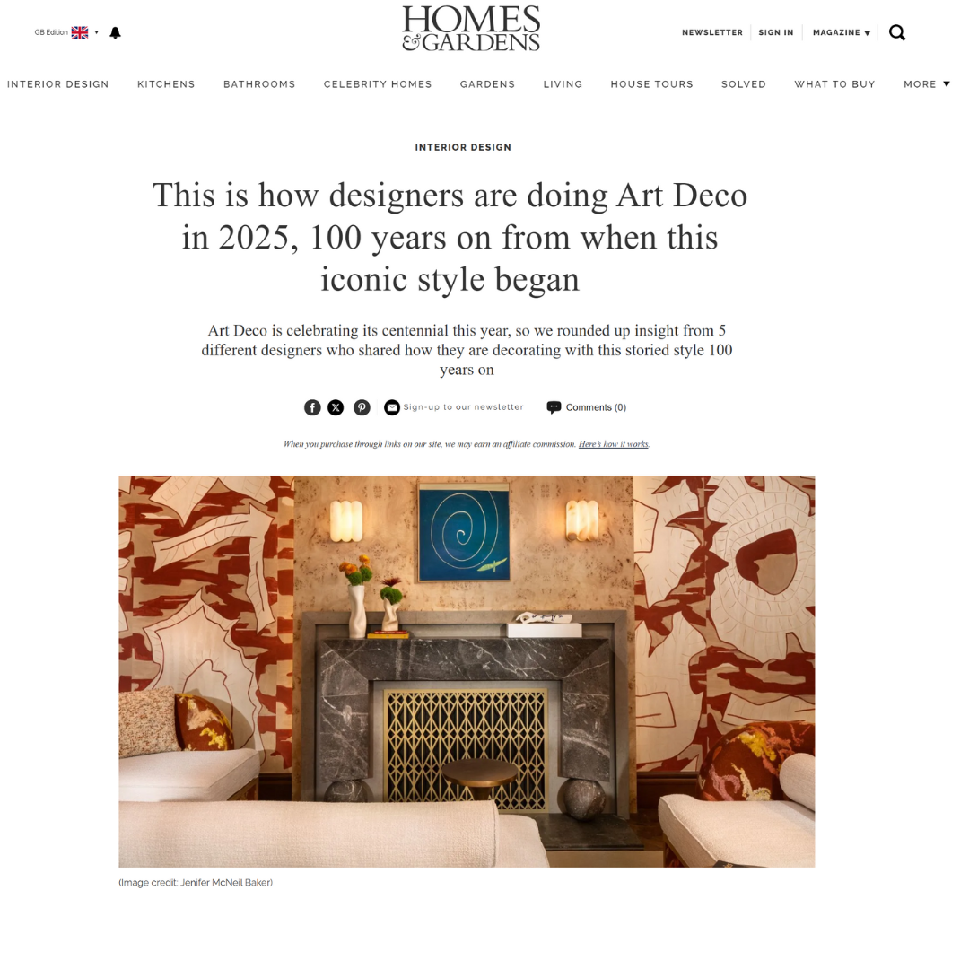 An article on Homes & Gardens showing a living room with bold Art Deco wallpaper, a dark marble fireplace with gold accents, a green and blue abstract painting above the mantel, and modern geometric chairs.