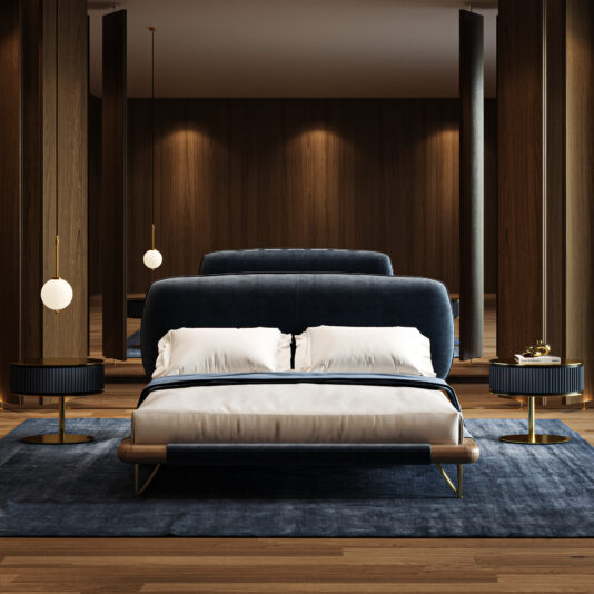 Contemporary High End Italian Bed Modern bedroom featuring a Contemporary High-End Italian Bed in dark blue, white bedding, two round bedside tables with black lamps, pendant lights, wood-panelled walls, and a blue rug on wooden flooring.