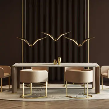 Contemporary Rectangular Stone Dining Table A modern dining room showcases beige chairs and the Contemporary Rectangular Stone Dining Table, enhanced by sleek gold accents and three gold bird sculptures on a dark, vertically striped wall for an elegant, minimalist look.