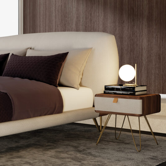 A modern bedroom with a beige upholstered bed, brown bedding, and pillows. A Contemporary Veneered Bedside Cabinet with gold legs holds books and a glowing lamp beside a textured brown wall.