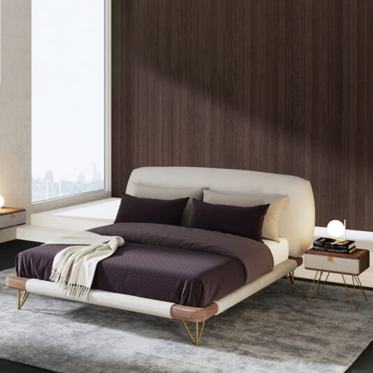 High End Contemporary Italian Bed A modern bedroom features the High-End Contemporary Italian Bed with dark bedding, a light upholstered headboard, and gold legs. Two bedside tables with round lamps and a grey rug complement the space, brightened by a large window.
