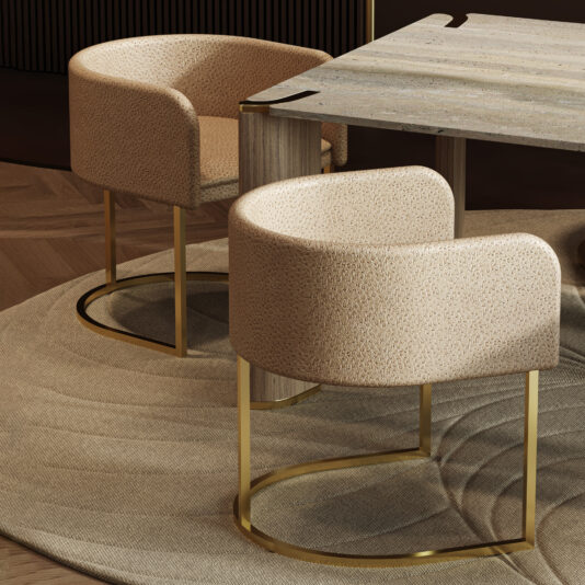 Two Modern Leather Tub Style Dining Chairs with gold metal bases are placed on a textured beige rug beside a wooden wavy table, creating a stylish, contemporary interior.