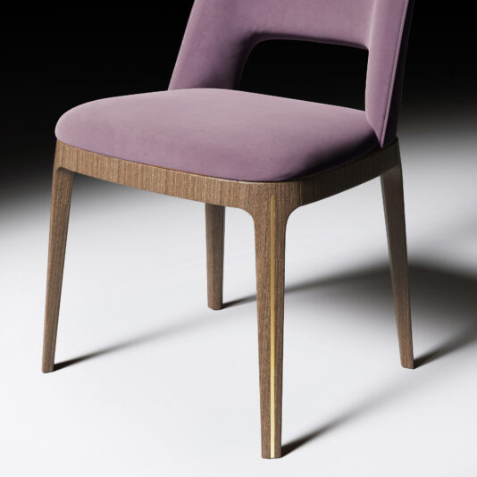 The Modern Minimalist Dining Chair features a soft purple upholstered seat and backrest, wooden legs, and a partially open lower back, all set against a neutral background.