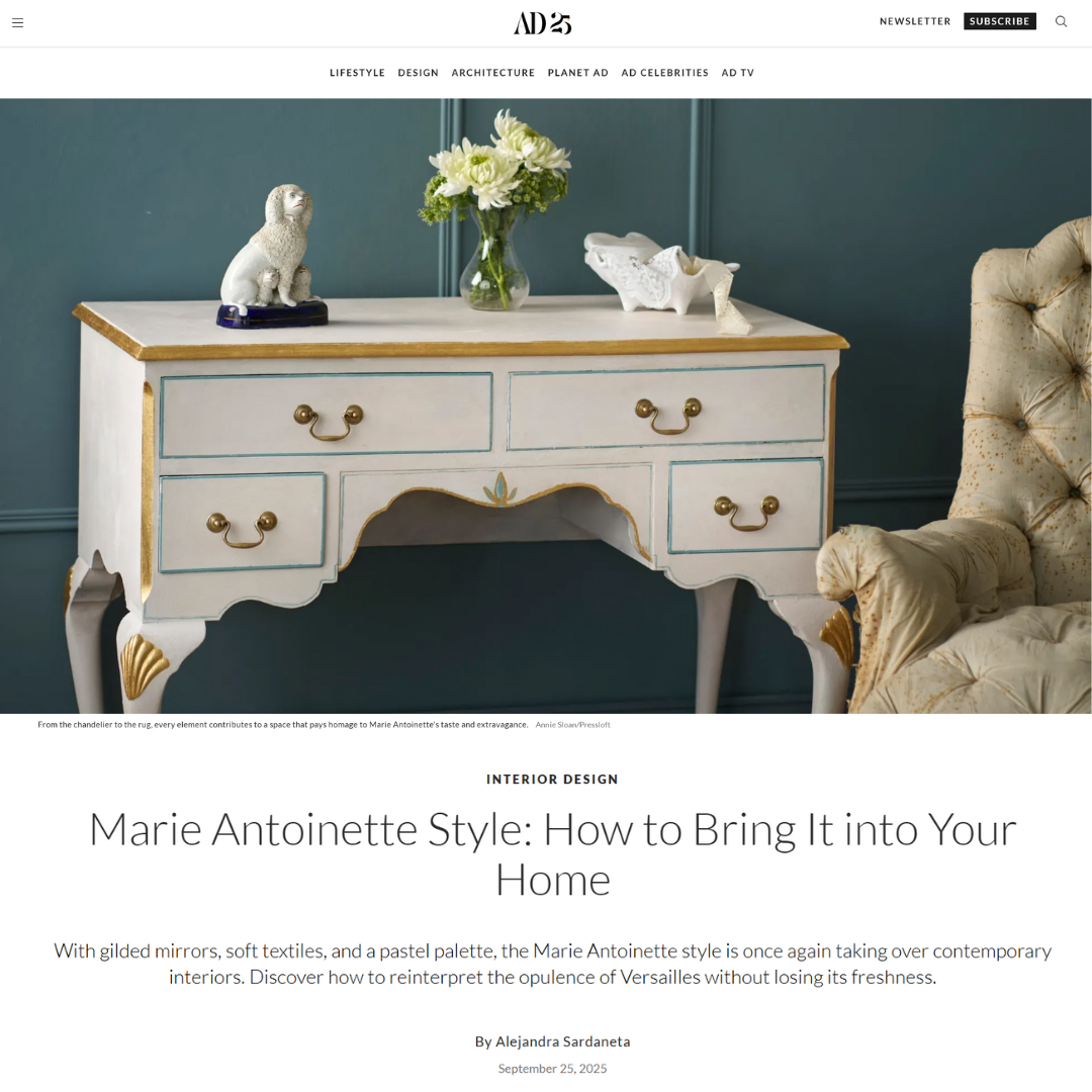 A pastel blue and white antique chest of drawers with gold accents stands against a beige wall. Decorative gilded swans serve as drawer handles, and ornate legs add elegance. A vase with greenery sits on top, evoking Marie Antoinette style.