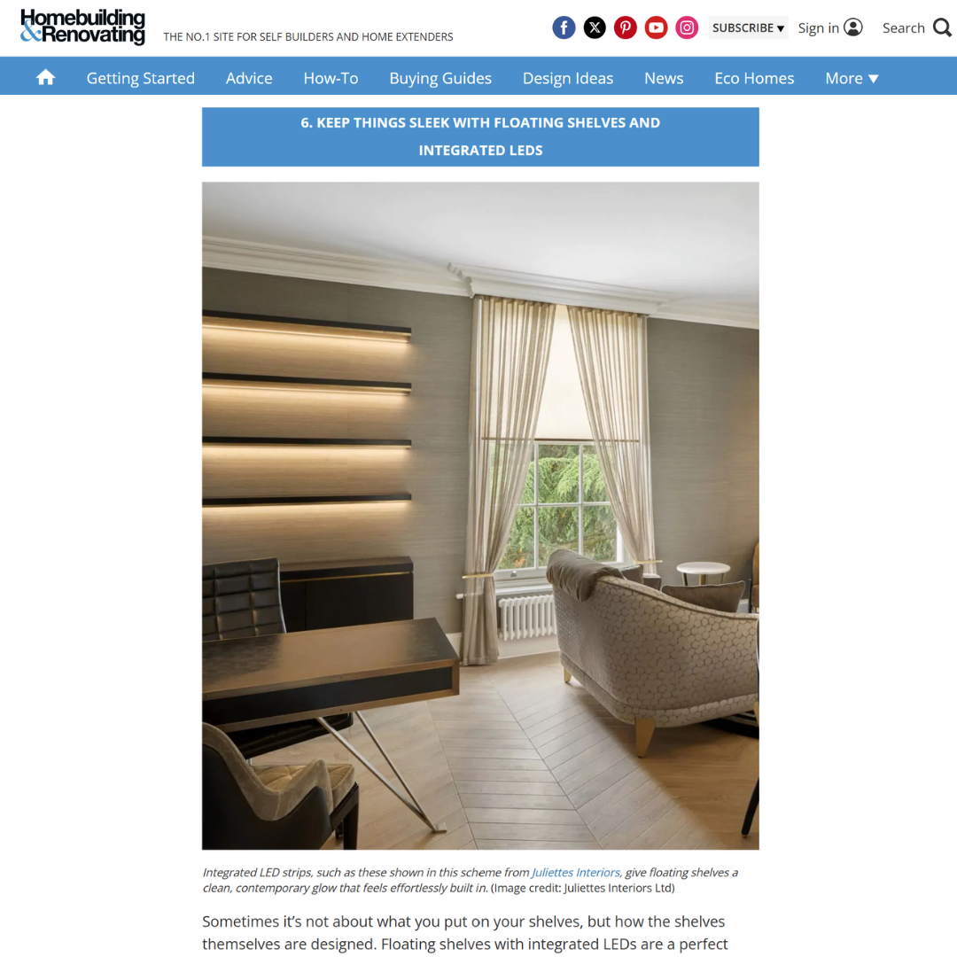 A modern living room with beige armchairs, a large window with tall cream curtains, and sleek floating shelves on the wall illuminated by integrated LED strips.
