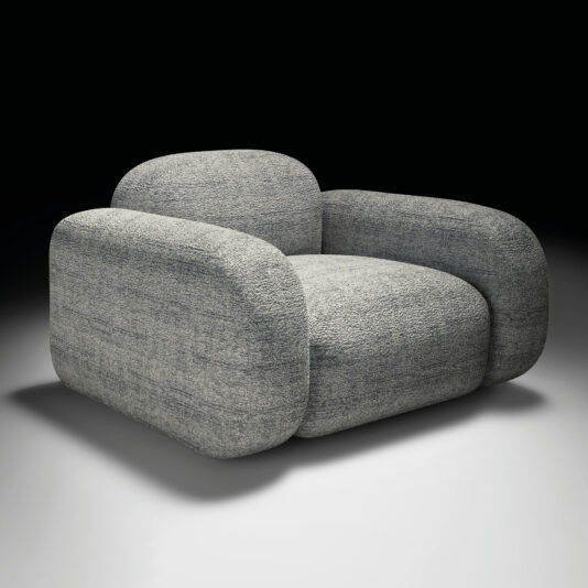 The Contemporary Italian Armchair is a modern oversized chair with rounded edges and thick padded cushions in textured grey fabric, set against a black-to-white gradient background.