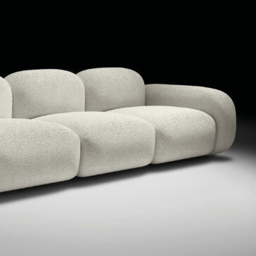 Contemporary Italian Sofa The Contemporary Italian Sofa features a modern, minimalist design with rounded edges and textured beige bouclé fabric, set against a black and white gradient background to highlight its elegant Italian style.