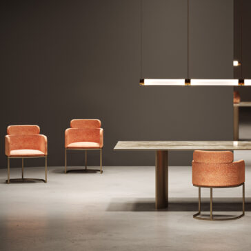 Contemporary Rectangular Faux Marble Dining Set Minimalist interior with three modern orange chairs, the Contemporary Rectangular Faux Marble Dining Set featuring a gold base, and two linear pendant lights set against a dark grey wall and concrete floor.