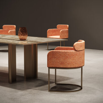 Contemporary Rectangular Faux Marble Dining Set A modern dining room features the Contemporary Rectangular Faux Marble Dining Set with four orange chairs and a textured brown vase on the table, enhancing the minimalist neutral dƩcor.