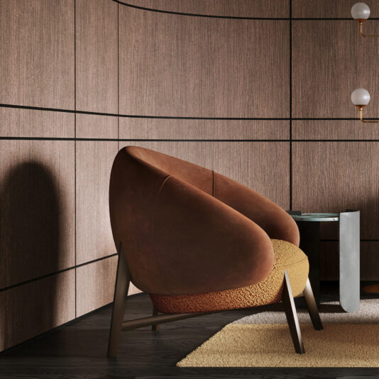 The Mid-century Style Italian Leather Armchair with brown and mustard upholstery is featured in a chic room with curved wood-panelled walls, a beige rug, a small glass table, and a wall-mounted lamp with round bulbs.