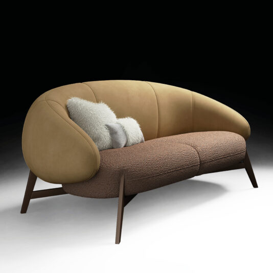 Mid Century Style Italian Leather Sofa The Mid-Century Style Italian Leather Armchair features tan leather upholstery on the back, textured brown fabric on the seat, curved armrests, dark wooden legs, and two light grey throw pillows for a modern, stylish look.