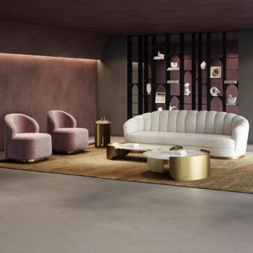 A modern living room features two Modern Velvet Occasional Chairs in mauve, a white textured sofa, gold and marble coffee tables, a brown rug, and a dark shelving unit with décor against mauve and grey walls.
