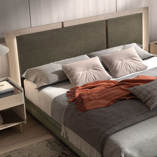 Contemporary Bed With Backlit Headboard A Contemporary Bed With Backlit Headboard features grey and white bedding, beige pillows, an orange throw blanket, and stands on a wooden floor beside a bedside table with a lamp and book.
