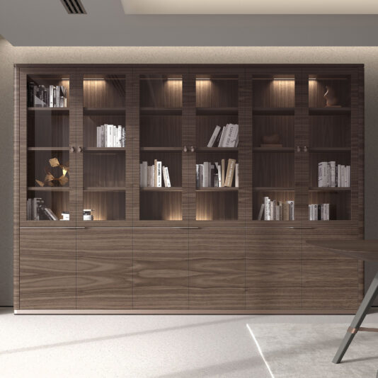 The Large Modern Walnut Veneer Bookcase features glass-fronted doors displaying books and decor on illuminated shelves, with closed cupboards along the lower section for additional storage.