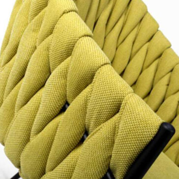 Set of 4 Woven Yellow Dining Chairs Close-up of the Set of 4 Woven Yellow Dining Chairs, featuring thick yellow-green fabric straps woven over a black metal frame for a textured, modern look.