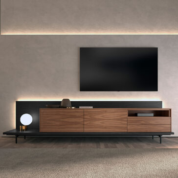 Walnut Veneer Media Sideboard A modern living room with a wall-mounted TV above the Walnut Veneer Media Sideboard, decorated with accents and a round lamp, all set against a light-toned textured wall.