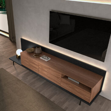 Walnut Veneer Media Sideboard A modern living room features the Walnut Veneer Media Sideboard against a light wall, topped with decor, a large flat-screen TV mounted above, and natural light coming in from the left window.