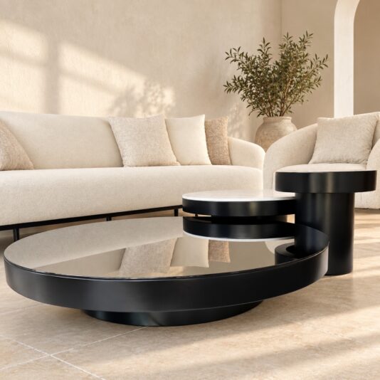 Modern round coffee table set showing the large black glass, medium marble-effect porcelain and small black tables in a neutral interior.