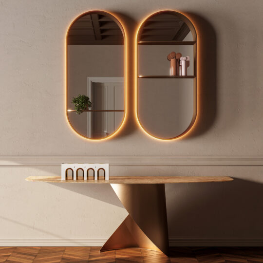 A modern entrance hall showcases the Modern Marble Console Table, two oval backlit wall mirrors, and minimalist decor—such as a small plant and pink vases on shelves inside the mirrors.