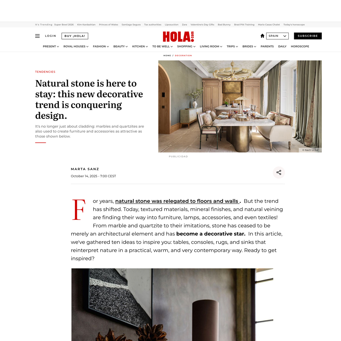 A modern living and dining area features a dining table with a marble top, velvet chairs, floor-to-ceiling curtains, a contemporary light fitting, and marble accents on the walls and floors.