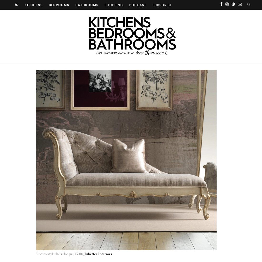 An elegant, vintage-style chaise longue with ornate wooden legs and frame, upholstered in light beige fabric, sits in a chic room with modern artwork and a large gold-framed mirror on the wall.