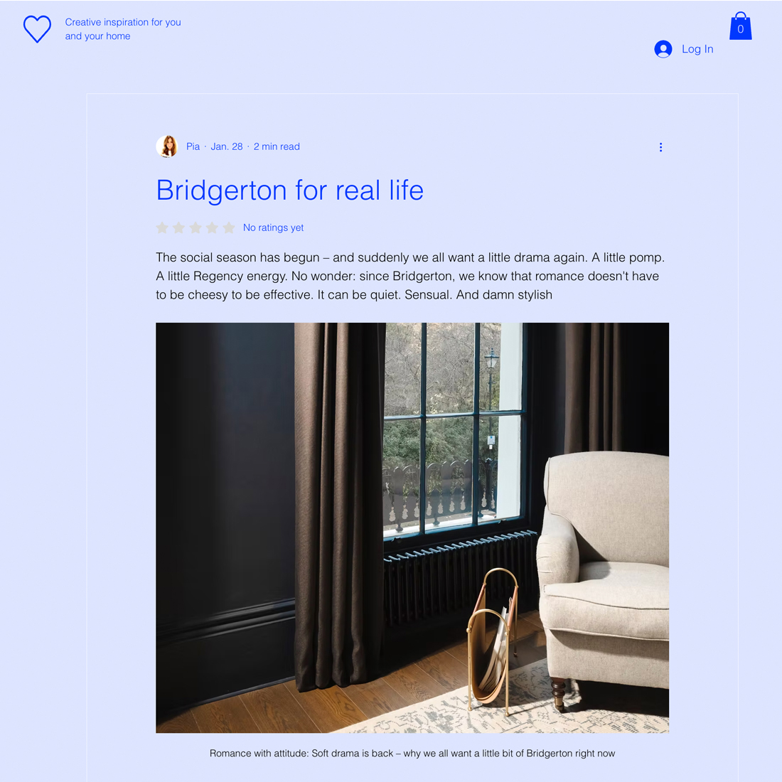 A sunlit room with tall windows draped in dark curtains, a light armchair beside the window, and a small round table with books and a glass on a patterned rug.