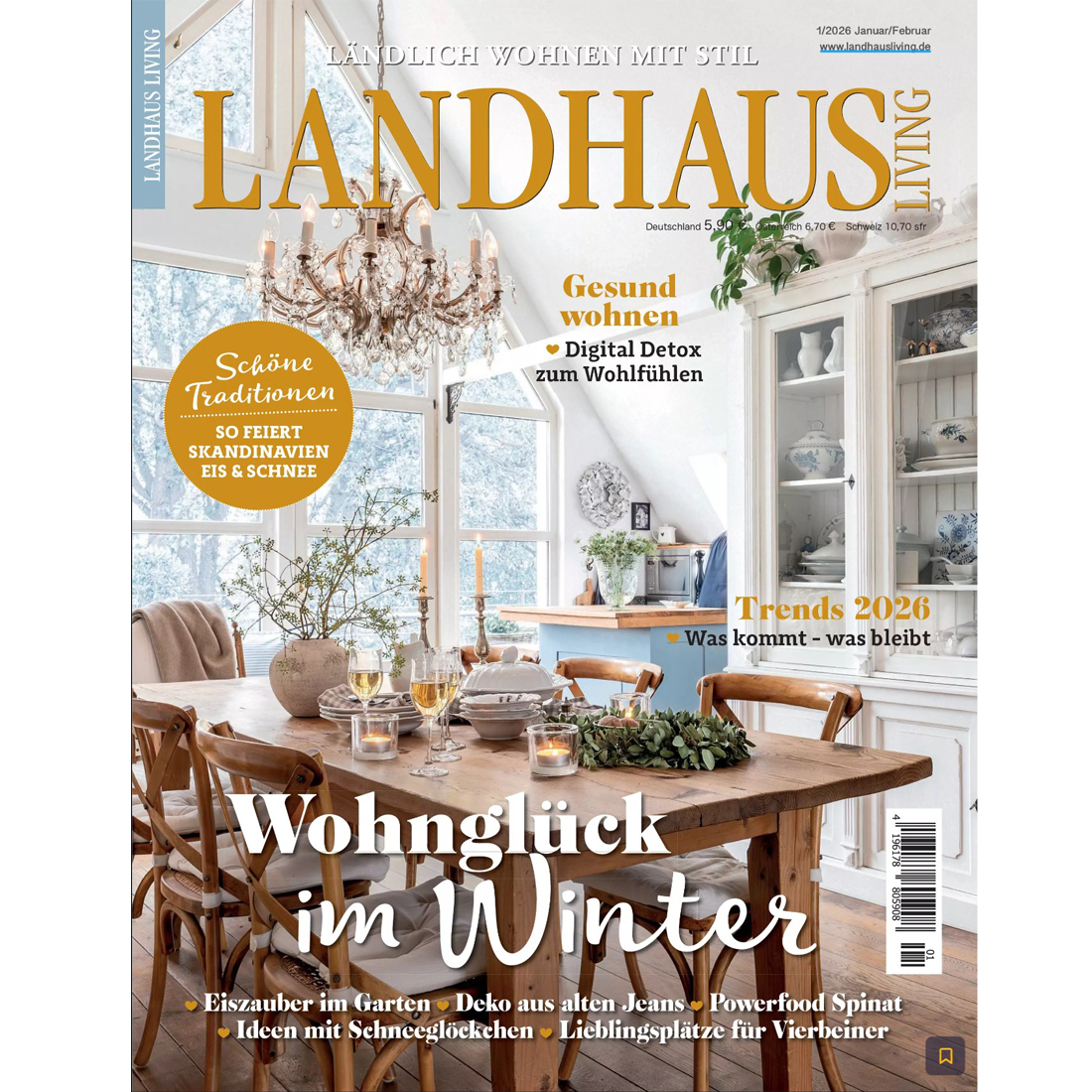 A cosy, rustic dining room with a wooden table set for winter, surrounded by chairs and large windows, decorated with candles, greenery, and a chandelier. The cover text is in German and highlights winter living trends.
